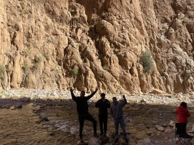 Travelers learning Berber traditions from local elders during cultural heritage tours Ouarzazate exploring ancient kasbah architecture