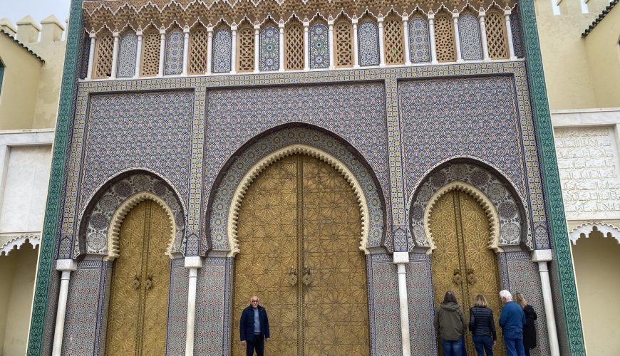 Travelers exploring ancient kasbahs and desert gates during comprehensive tours Ouarzate showcasing Berber heritage