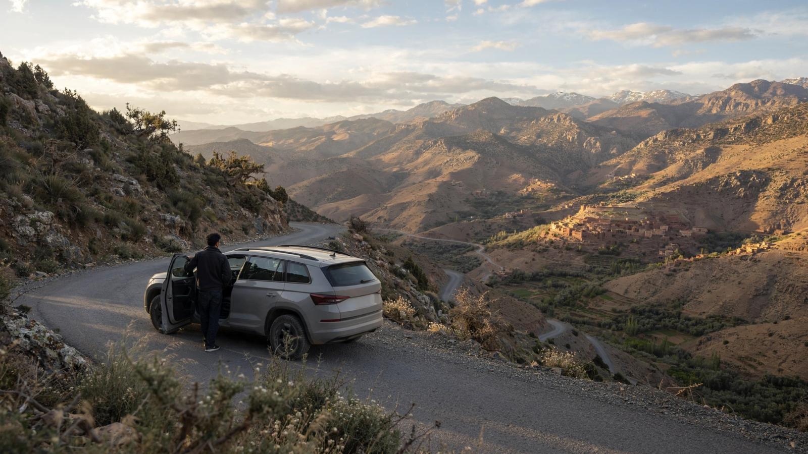 Travelers reviewing a car rental with driver budget on a terrace in Morocco