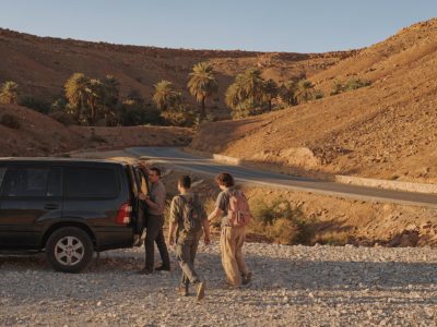 A private vehicle parked on a desert road near Ouarzazate during a scenic excursion from Ouarzazate
