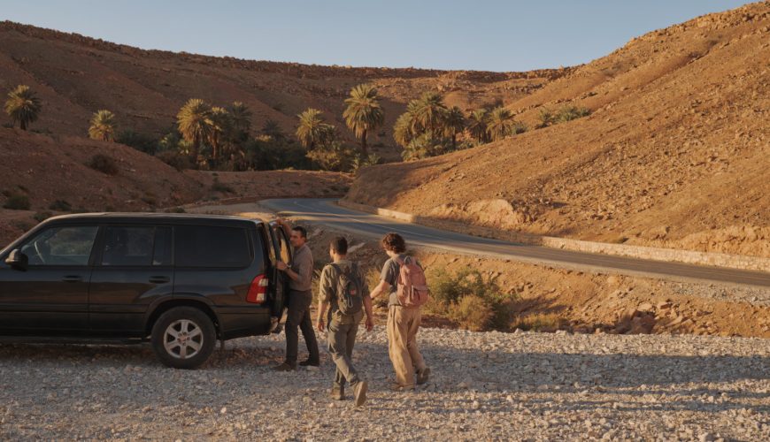 A private vehicle parked on a desert road near Ouarzazate during a scenic excursion from Ouarzazate