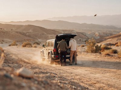 Family Morocco Tours minivan parked on a scenic road in the High Atlas with parents and children stretching their legs