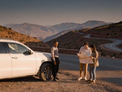 Travelers planning Morocco driver tours with a private driver beside a mountain road