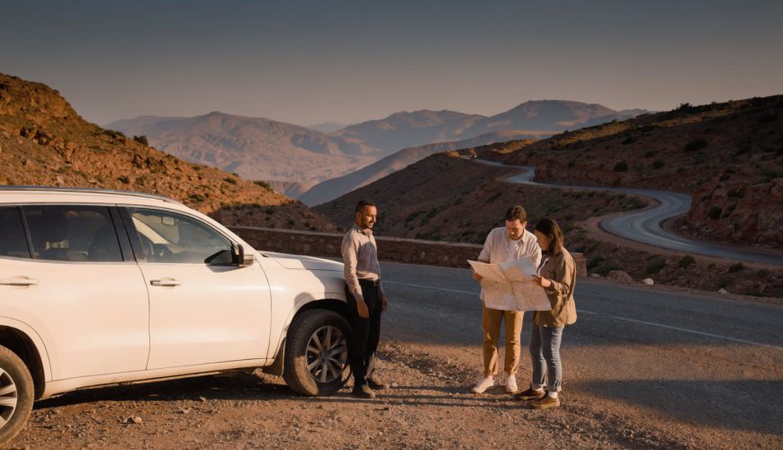 Travelers planning Morocco driver tours with a private driver beside a mountain road